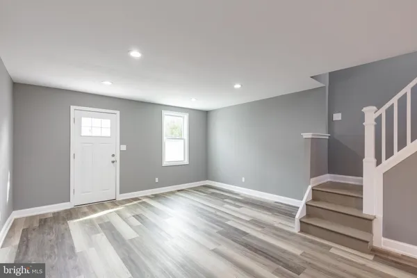 a view of wooden floor and windows in a room