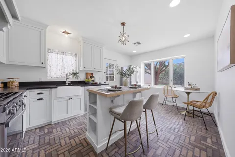 a kitchen with stainless steel appliances kitchen island granite countertop a sink and cabinets
