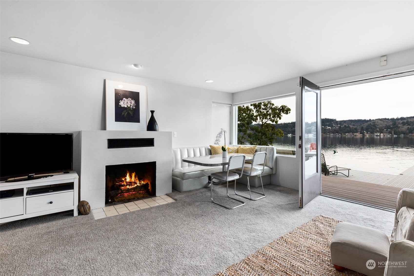 11730 Riviera Place Northeast Seattle, WA 98125 - Photo 25 of 34 a living room with furniture a flat screen tv and a fireplace