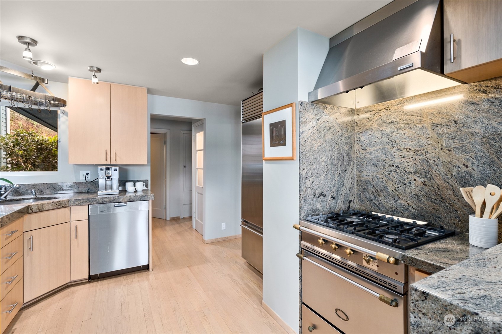 11730 Riviera Place Northeast Seattle, WA 98125 - Photo 10 of 34 a kitchen with stainless steel appliances granite countertop a stove a sink and a refrigerator