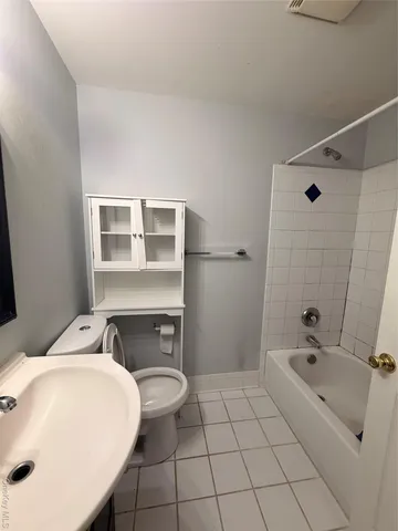 a spacious bathroom with a granite countertop sink toilet and shower