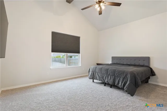 a spacious bedroom with a bed and a window