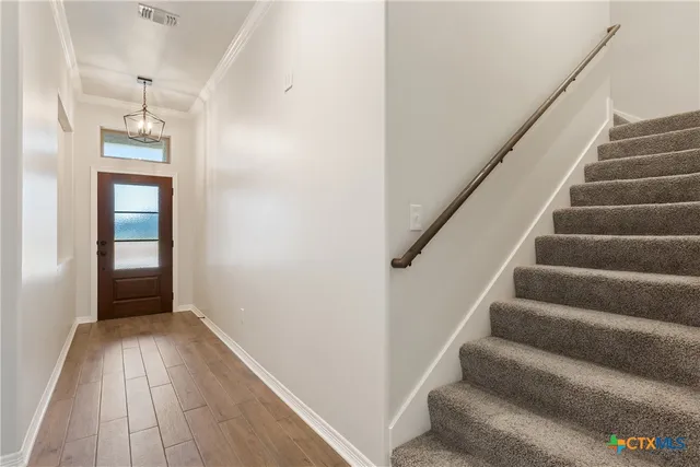 a view of entryway and hall with wooden floor
