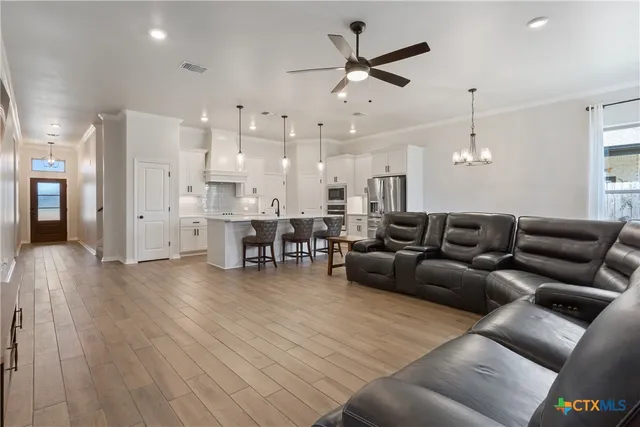 a living room with furniture and kitchen view