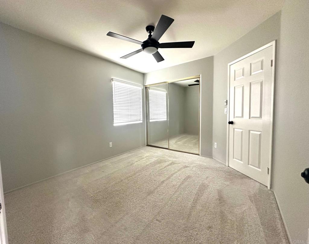 652 Montage Road Oceanside, CA 92057 - Photo 11 of 15 an empty room with ceiling fan and windows