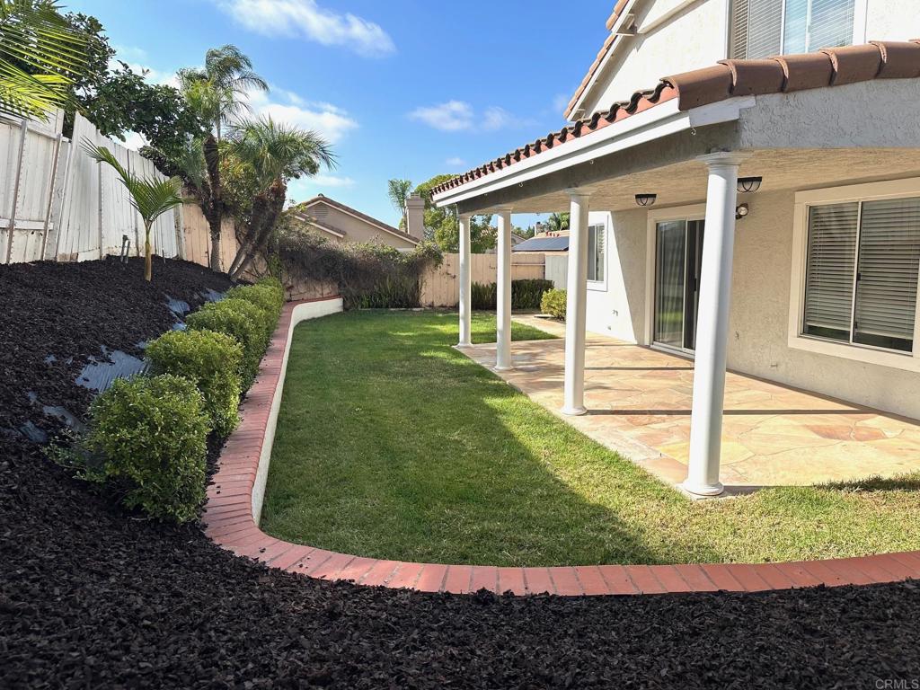 652 Montage Road Oceanside, CA 92057 - Photo 14 of 15 a view of a white house with a yard