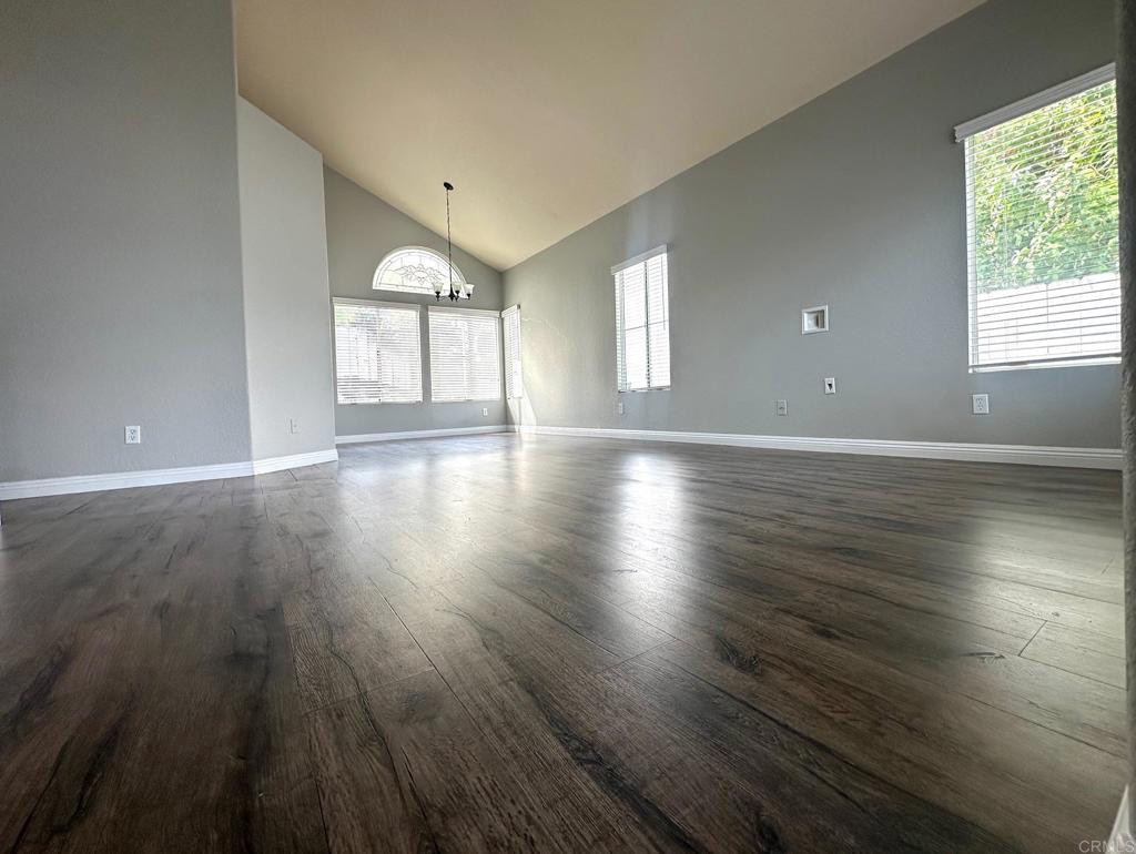 652 Montage Road Oceanside, CA 92057 - Photo 3 of 15 an empty room with wooden floor and windows