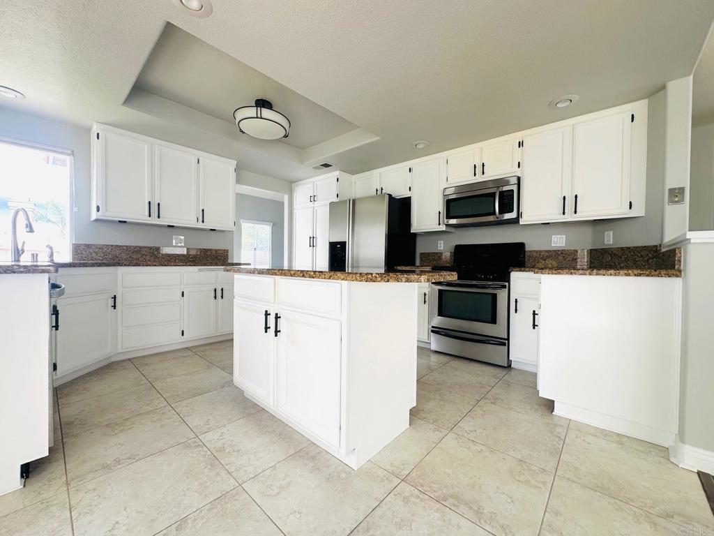 652 Montage Road Oceanside, CA 92057 - Photo 4 of 15 a kitchen with cabinets and white stainless steel appliances