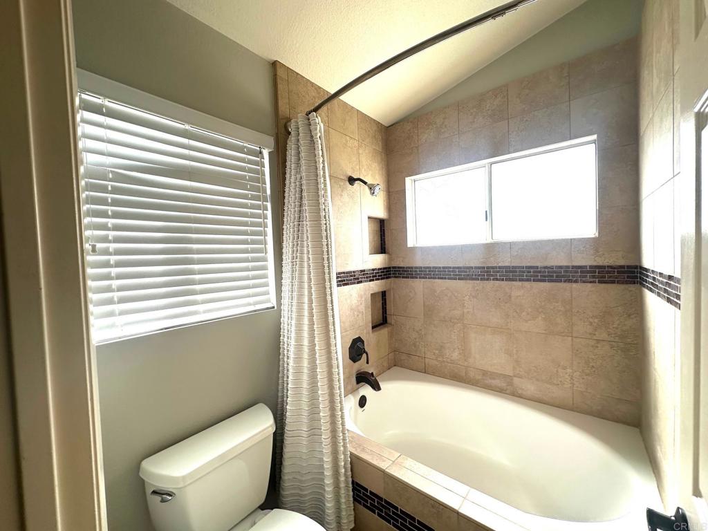 652 Montage Road Oceanside, CA 92057 - Photo 9 of 15 a bathroom with a bathtub and a toilet