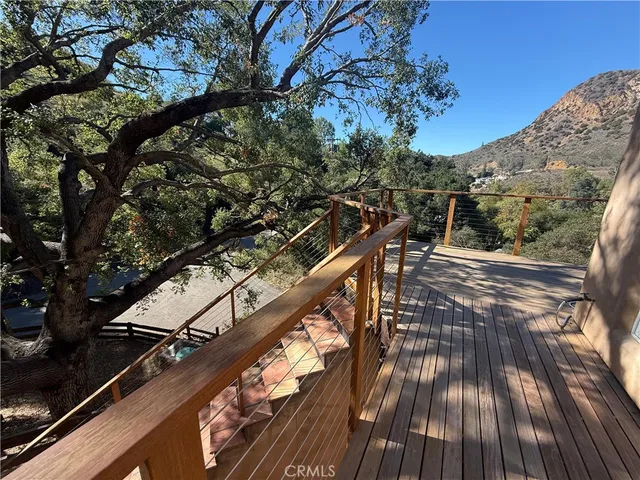 a view of balcony with wooden floor and seating space