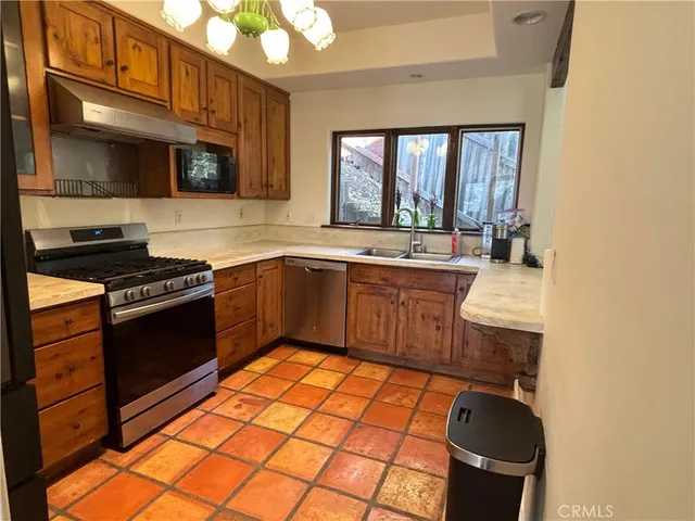 a kitchen with a sink stove and microwave