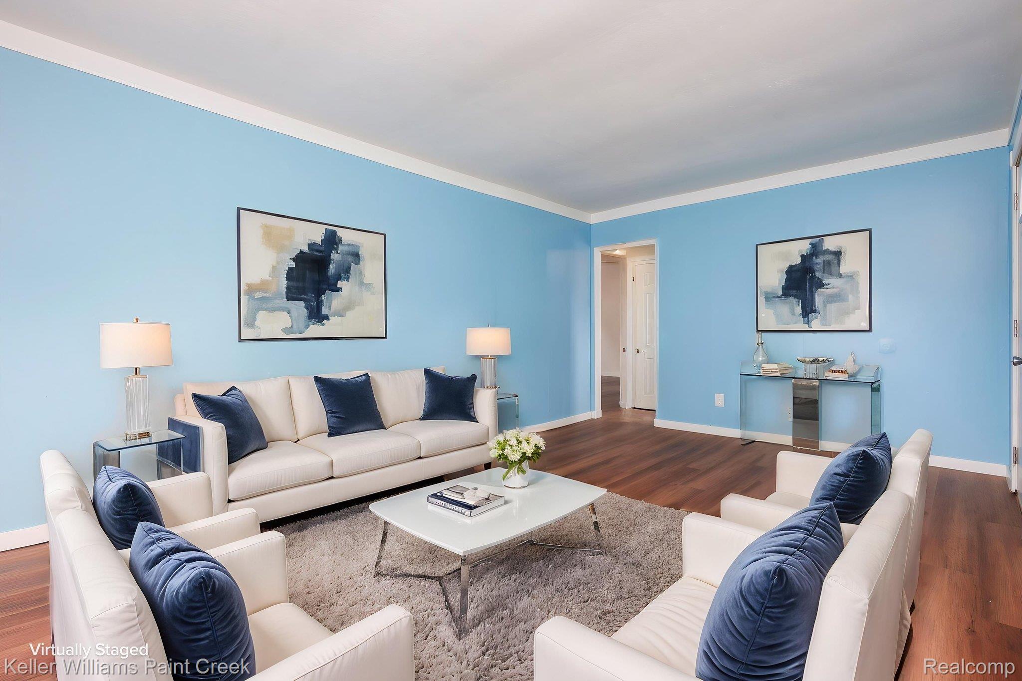 2244 Hammerslea Road Lake Orion, MI 48359 - Photo 10 of 21 Spacious living area featuring wood-finish flooring, light blue walls, and white crown molding
