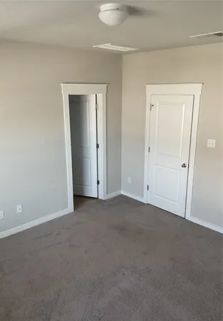 a view of an empty room and closet area