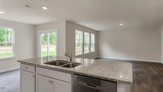 a kitchen with a sink cabinets and window