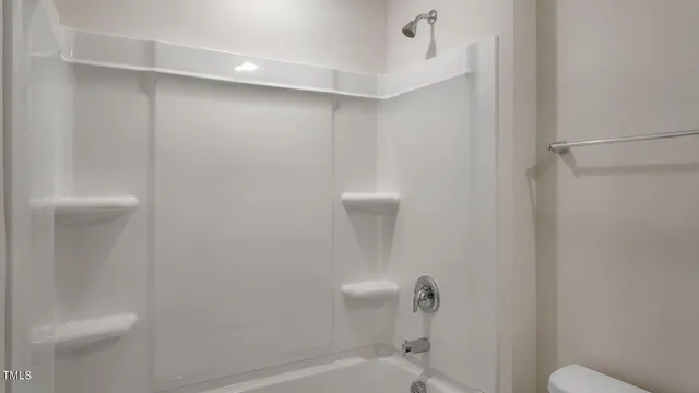 a bathroom with a shower and toilet