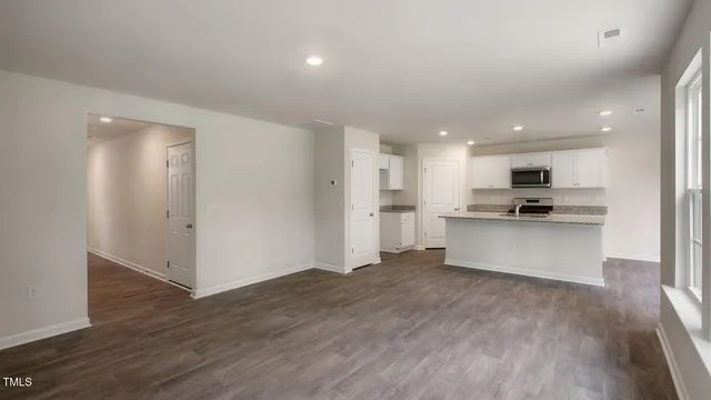 a view of kitchen view with wooden floor and stainless steel appliances