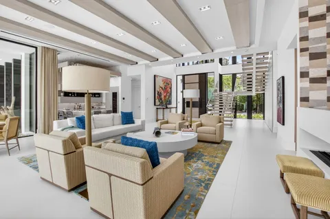 a living room with furniture and large windows