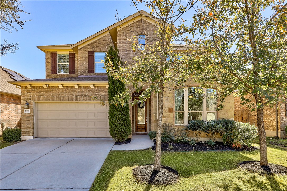a front view of a house with garden