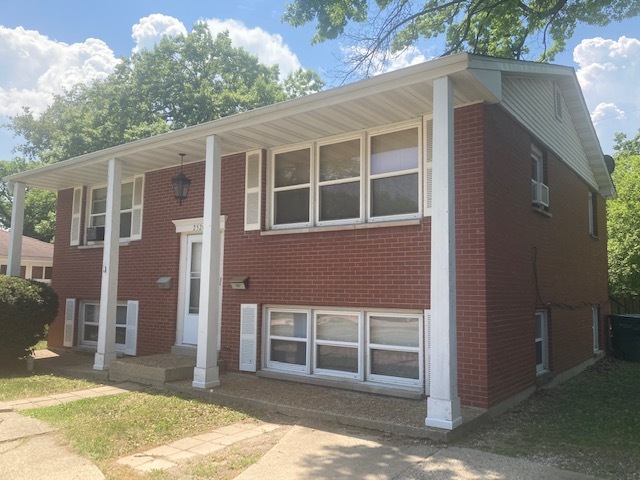 2520 North Linden Avenue Waukegan, IL 60087 - Photo 1 of 12 a front view of a house with a yard
