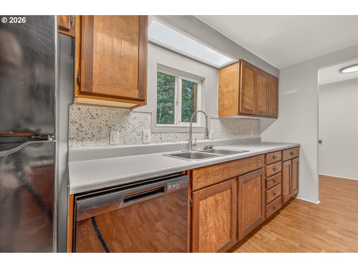 32231 Bishop Road Rainier, OR 97048 - Photo 11 of 26 a kitchen with stainless steel appliances granite countertop a sink and a wooden cabinets
