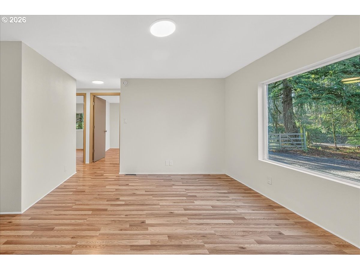 32231 Bishop Road Rainier, OR 97048 - Photo 13 of 26 a view of an empty room with wooden floor and a window