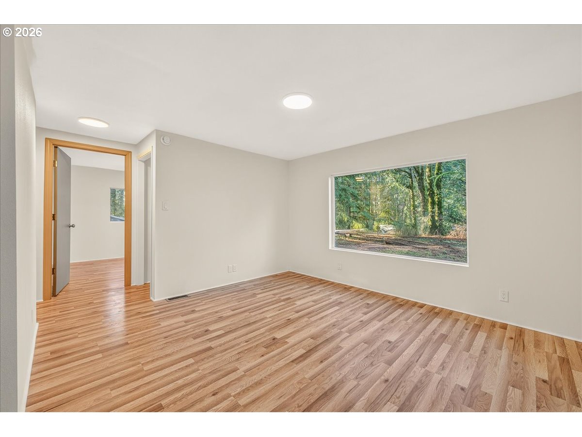 32231 Bishop Road Rainier, OR 97048 - Photo 14 of 26 a view of an empty room with window and wooden floor