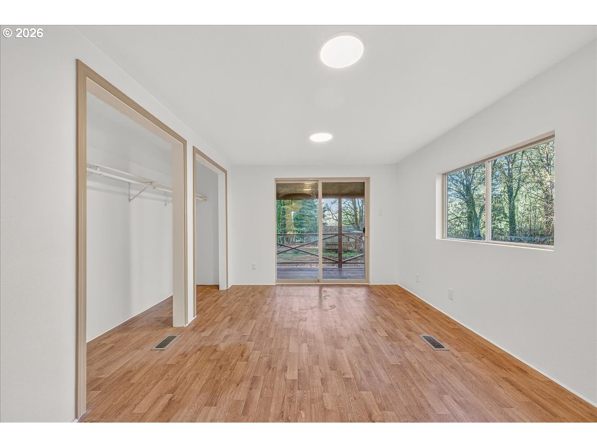 32231 Bishop Road Rainier, OR 97048 - Photo 15 of 26 a view of an empty room with wooden floor and a window