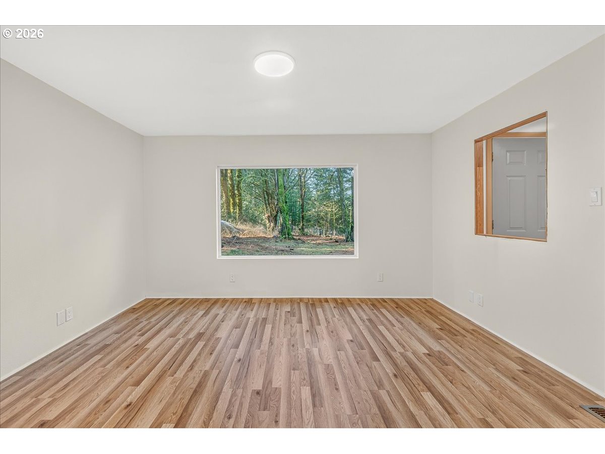 32231 Bishop Road Rainier, OR 97048 - Photo 19 of 26 a view of an empty room with wooden floor and a window