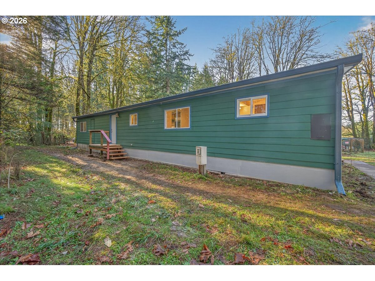 32231 Bishop Road Rainier, OR 97048 - Photo 3 of 26 a backyard of a house with table and chairs