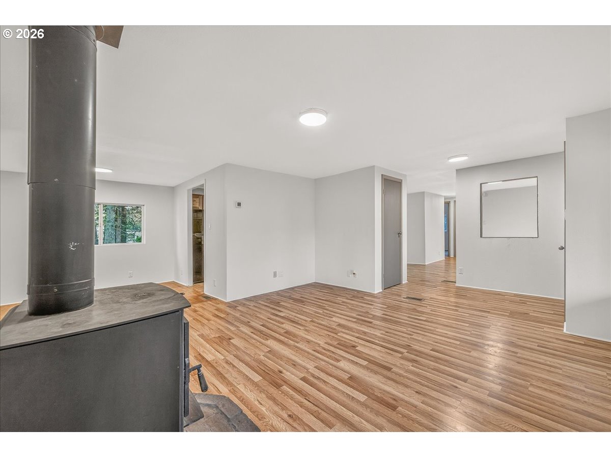 32231 Bishop Road Rainier, OR 97048 - Photo 8 of 26 a view of kitchen and empty room with wooden floor