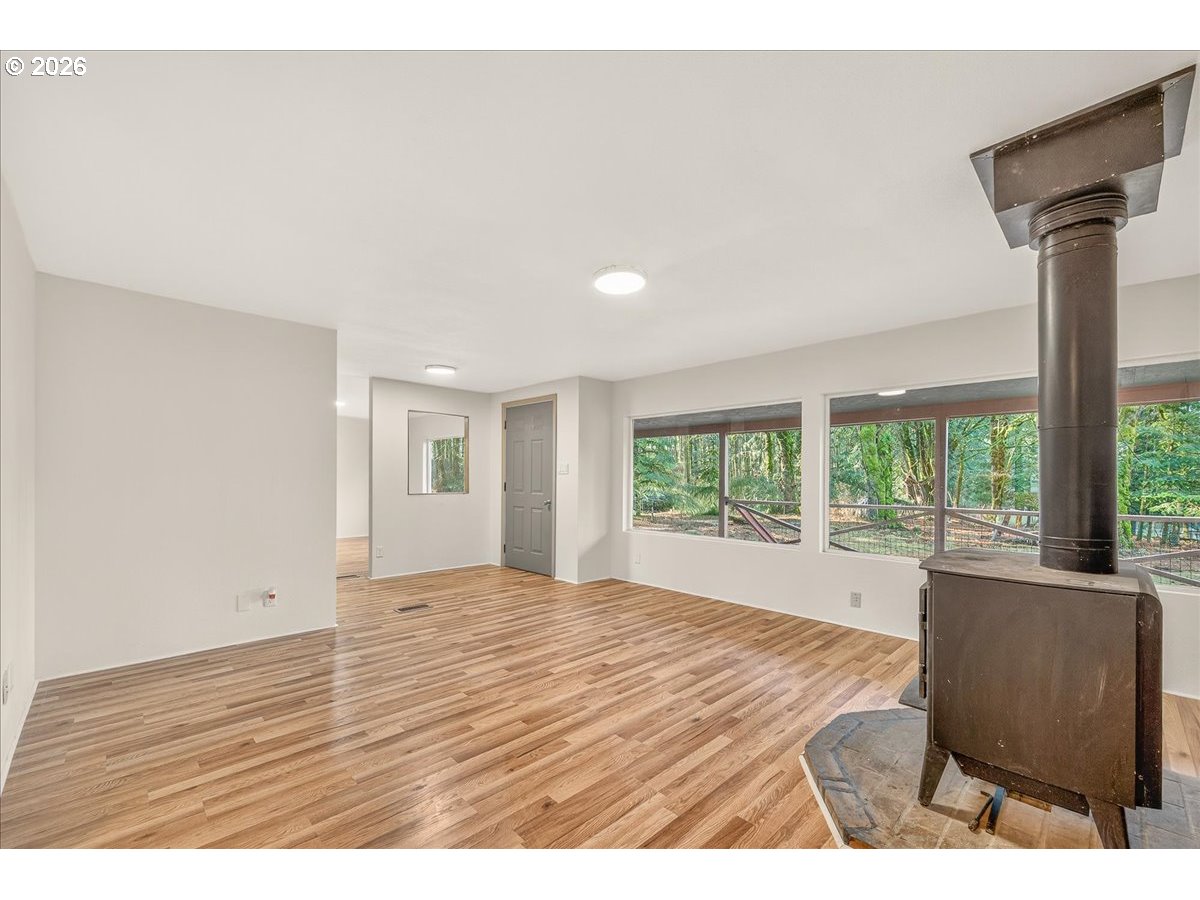 32231 Bishop Road Rainier, OR 97048 - Photo 9 of 26 a view of an empty room with wooden floor and a window