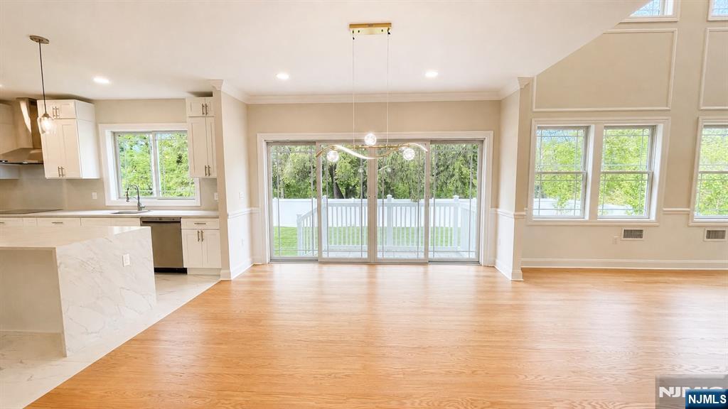 405 Valley Road River Edge, NJ 07661 - Photo 7 of 20 a view of an empty room with wooden floor and a window