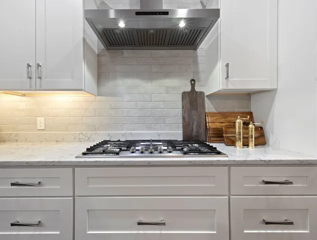 a white stove top oven sitting inside of a kitchen