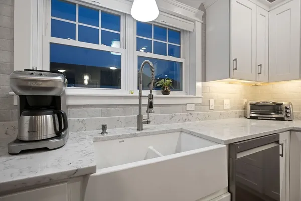 a white stove top oven sitting inside of a kitchen