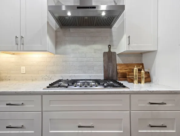 a kitchen with a sink a counter space appliances and wooden floor