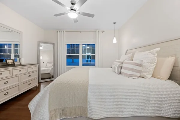 a bedroom with bed and a chandelier