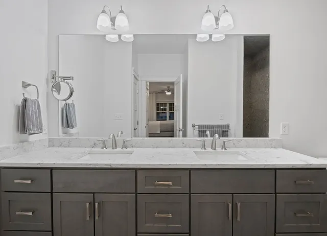 a bathroom with a sink vanity and a mirror
