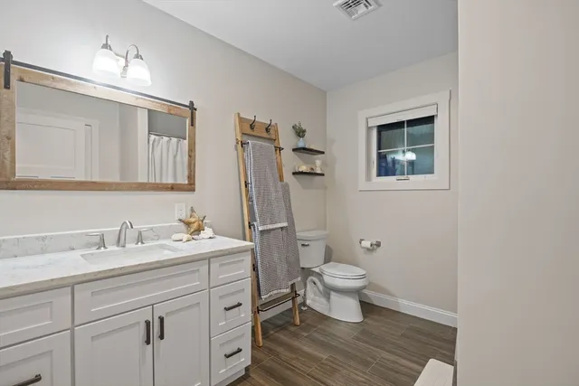 a bathroom with a sink toilet and shower