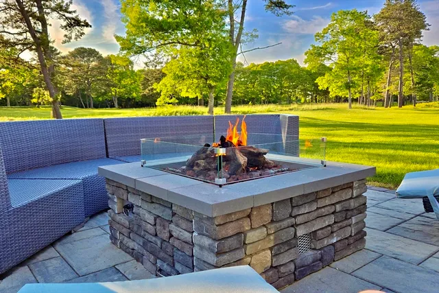 a view of a backyard with a table and chairs