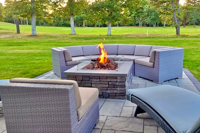 a view of a big yard with a patio
