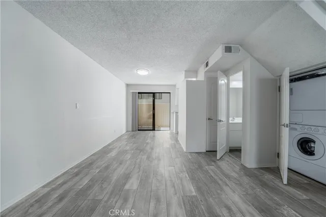 a view of a big room with wooden floor and a ceiling fan