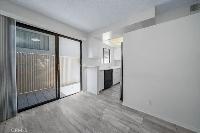 a view of a kitchen cabinets wooden floor and a window