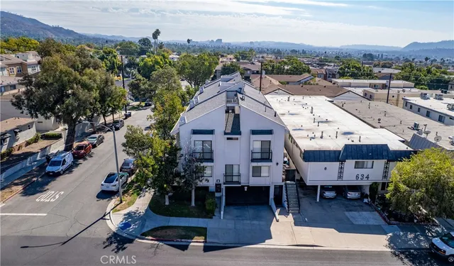 an aerial view of houses with yard