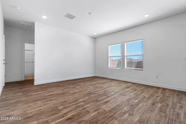 a kitchen that has a lot of cabinets and wooden floor