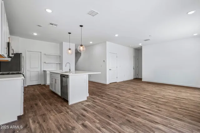 an empty room with windows and closet