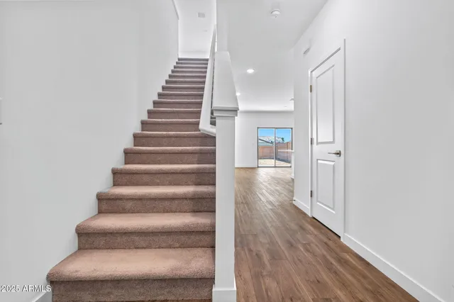 a view of an entryway with wooden floor