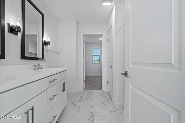 a spacious bedroom with a bed and a window