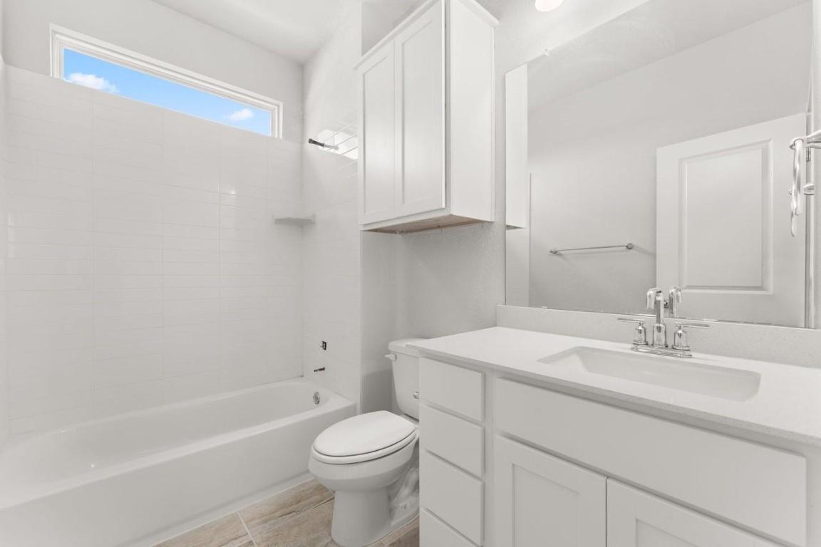 2200 Grenache Drive, Unit 105 Round Rock, TX 78664 - Photo 11 of 15 a bathroom with a sink a toilet and shower