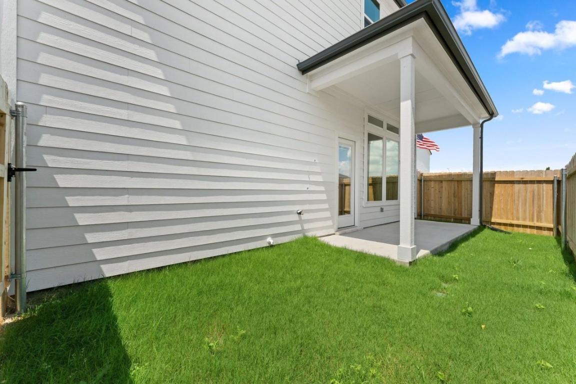 2200 Grenache Drive, Unit 105 Round Rock, TX 78664 - Photo 14 of 15 a view of a house with a backyard