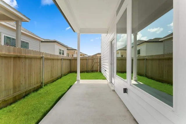 a view of a back yard with a wooden fence